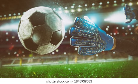 Close up of a goalkeeper catching the ball in the stadium during a football game - Powered by Shutterstock