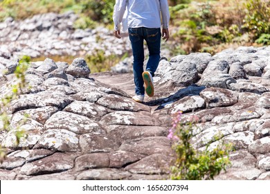 close up of going legs on path , hiking shoes in action on a mountain desert trail path.