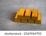 Close up gold bars pile on grey background