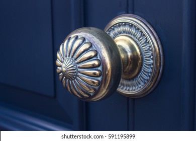 Close Up Gold Metal Door Knob On A Blue Exterior House Door.