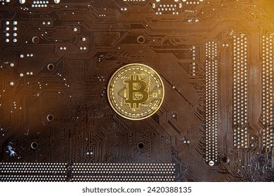 Close up of golden Bitcoin coins on electronic circuit board use for Cryptocurrency Business , finance , trading or investment concept background