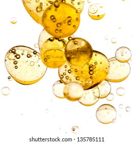 Close up of golden bubbles on illuminated background