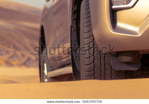Close up of a golden car\
stuck in the sand in the Namib desert. Walvis Bay, Namibia, Africa\
07.02.2020