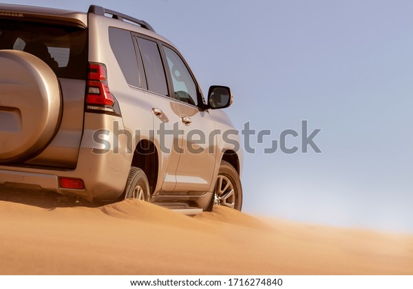 Close up of a golden car stuck in the sand in\
the Namib desert. Africa.\
28.04.2020
