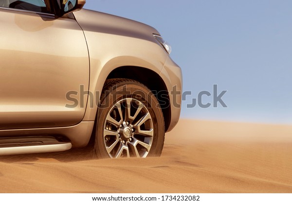 Close up of a golden car stuck in the sand in the\
Namib desert. Africa