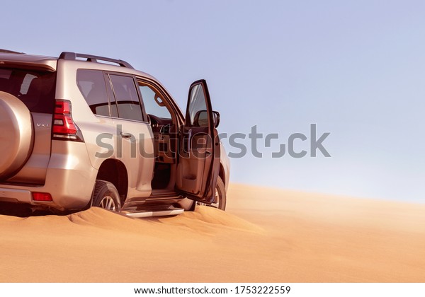 Close up of a golden car stuck in the sand in\
the Namib desert. Africa.\
10.06.2020