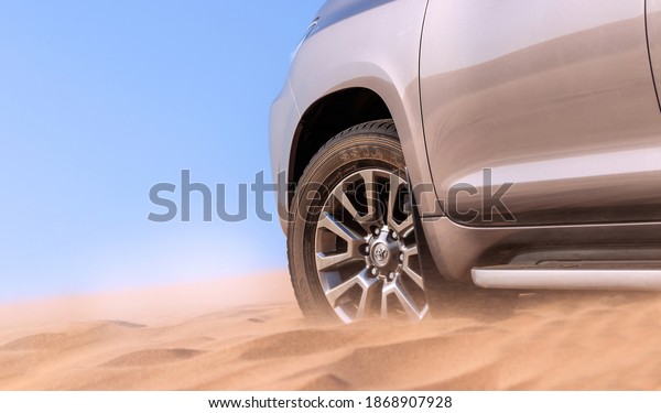 Close up of a golden car stuck in the\
sand in the Namib desert. Africa. Namibia\
06.12.2020