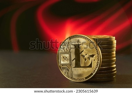 Close up of golden cryptocurrency litecoin LTC with red gradient background