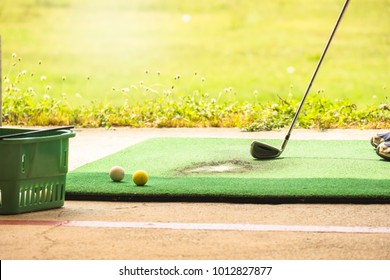 Close up of golf balls and a golf wood on a golf driving range  - Powered by Shutterstock