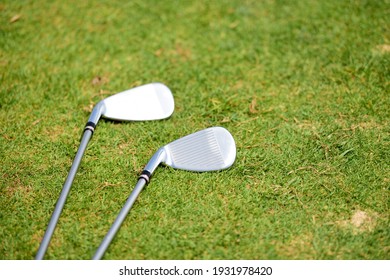 Close Up Of A Golf Club Iron Head On Green Grass With Club