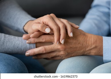 Close Up Granddaughter Comforting Grandmother, Young Woman Daughter Holding Older Mother Hands, Expressing Love And Support, Good Trusted Family Relationship, Two Generations, Care To Senior People