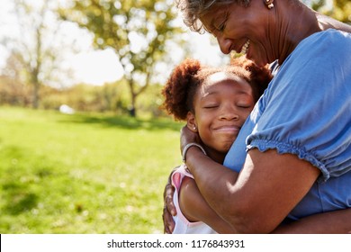 Close Up Of Granddaughter Hugging Grandmother In Park