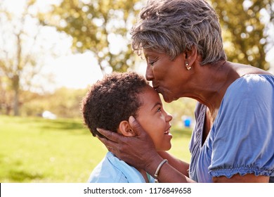 Close Up Of Grandmother Kissing Grandson In Park