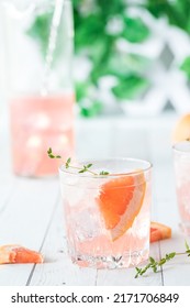 Close Up Of Grapefruit Spritzer With Slices Of Grapefruit And Thyme.