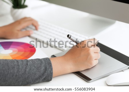 close up graphic design using digital pen tablet on desk workspace