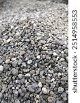 Close up gravel, grey pebbles, pile of stones with background blur and copy space.