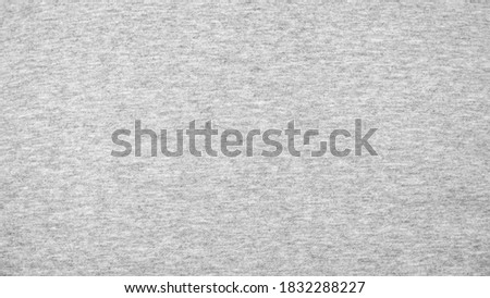 Close up gray cotton heather texture background.  
Black and white textured knit fabric pattern seamless.
Selective focus.
top view.