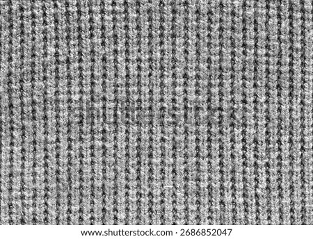 A close up of a gray fabric with a pattern of lines. The fabric is made of wool and has a fuzzy texture