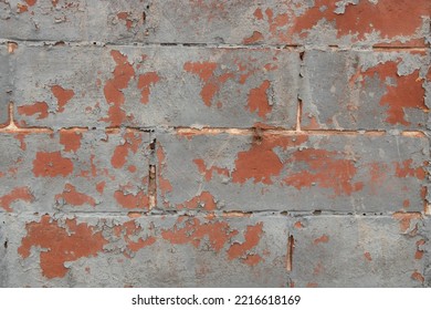 Close Up Of A Gray And Red Brick Wall With Distressed Paint