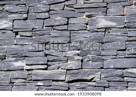 Close up of a gray Welsh slate wall.  Decorative stone abstract background.