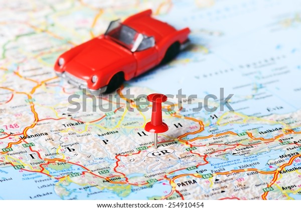 Close up of  Greece map  red pin and car toy - Travel
concept 