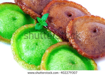 Close up of green and brown kuih Pinjaram on a plate, Kuih Pinjaram is a traditional kuih for Bajau, Bruneian Malay people in Brunei and in the states of Sabah in East Malaysia. Made from rice flour.