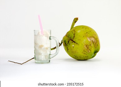 close up green coconut with coconut water in glass on white background