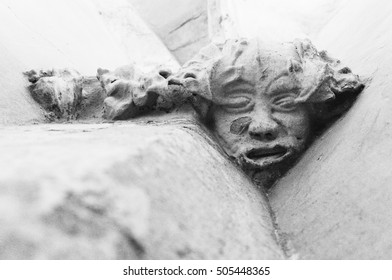 Close Up Of Green Man Pagan God Statue In Richis Church, Romania In Black And White. 