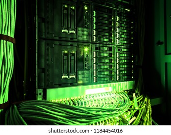 Close up of green network internet cables, patch cords connected to black switch router in Data center, server room. - Powered by Shutterstock