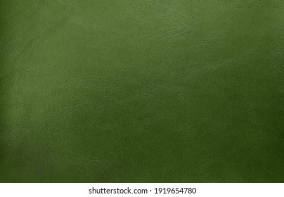 close up green olive leather texture background. abstract vintage concept background. top view of genuine leather.