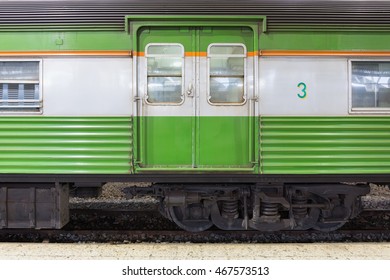 Close up of a green passenger carriage bogie on a train platform. - Shutterstock ID 467573513