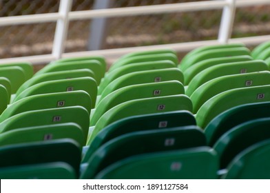 Close Up Of Green Stadium Seats. Plastic Seat Rows At Sports Arena. Pattern Texture Of Set Chairs. Empty Venue Due To Covid 19 Crisis. Ticket Sales. Select Focus. Bokeh Effect.