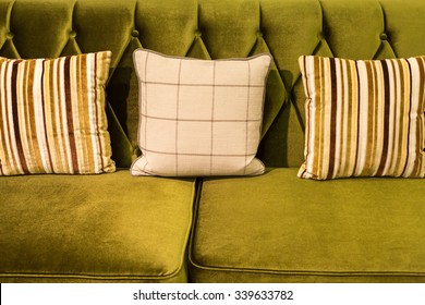 Close Up Of Green Velvet Sofa And Cushions With Vintage Style.