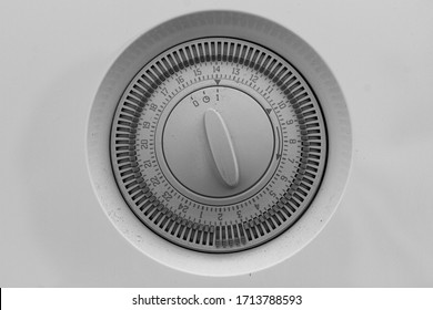 Close up of a grey boiler mechanical timer dial