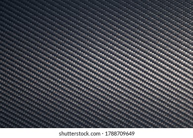 Close Up Of Grey Diagonal Oriented Woven Carbon Fibre Sheet Surface. Texture And Pattern Background. Modern Technology And Material Concept.

