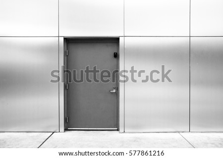 close grey door with aluminium or steel wall