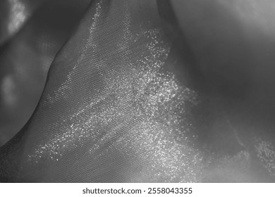 Close up of grey tulle fabric as a background with shine and gloss. Organza fabric with soft folds as backdrop for cosmetic products, beauty, jewelry.Cloud silver coin fog smoke ash dove pewter gray - Powered by Shutterstock