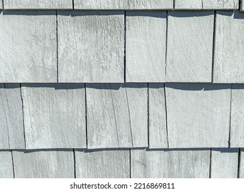 Close Up Of Grey Wooden House Shingles. Weathered Wood Siding On A House. Textured Wooden Background