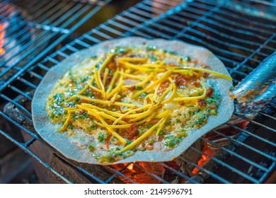 Close up Grilled girdle cake (Banh Trang Nuong) , a famous Vietnamese street stall eatery, a popular Vietnamese food in Da lat at night