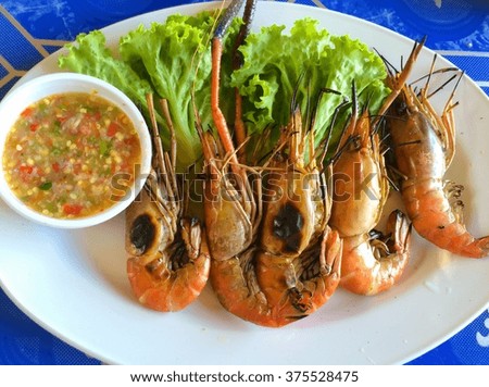 close up grilled prawn on white dish with sea food sauce