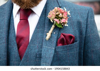 Close Up Of Groom Wearing Tweed Suit And Boutonniere