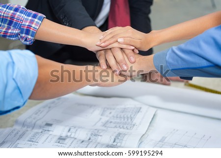 Close up group of Asian Construction engineer,worker,Asian foreman and owner  shake up their hand after achieve their mission or construction.
