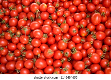 Close up of group of fresh red tomatoes at a farmers market. Healthy food. Organic vegan background