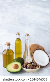 A Close Up Of A Group Of Healthy Cooking Oils Including Olive Oil, Coconut Oil And Avocado Oil. A Healthy Fats Concept.