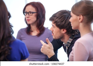 Close Up Of Group Of People. Discussing Something Interesting In A Circle 