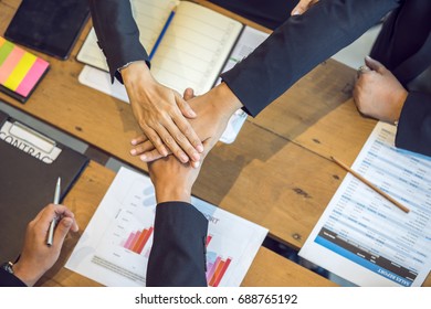 Close up group of peoples joining hands on top for starting business project. - Shutterstock ID 688765192