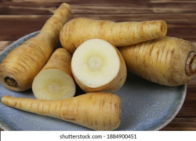 Close Up Of Group Raw Isolated Sliced Parsnip Root Vegetables On Blue China Plate