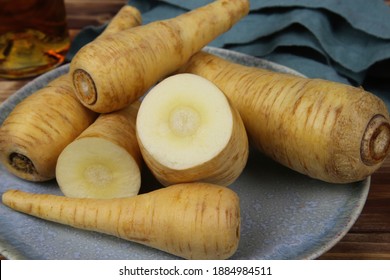 Close Up Of Group Raw Isolated Sliced Parsnip Root Vegetables On Blue China Plate