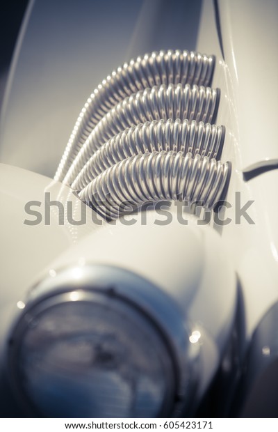Close up of a group of shiny exhaust pipes on a\
vintage car