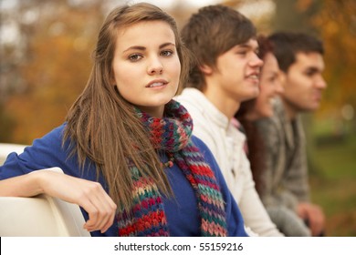 Close Up Of Group Of Teenage Friends In Autumn Park